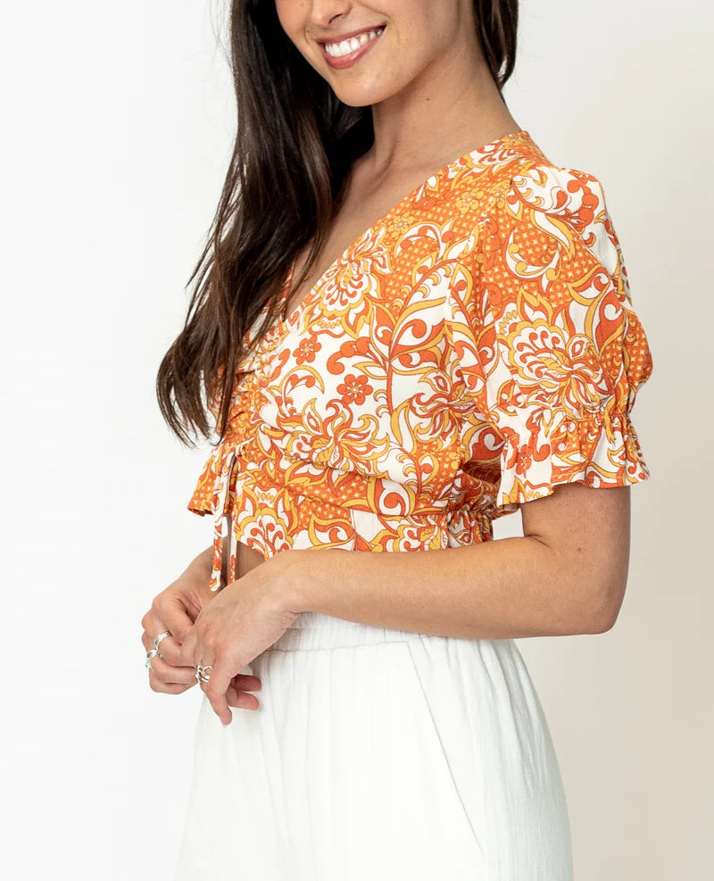 Tali V Neck Front Cinch Printed Top In Orange